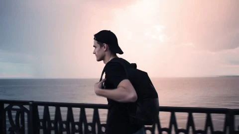Tourist Man with Backpack Walking on Beach by Sunset Sea 스톡 동영상 79037777