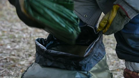 Tourist man gets things out of backpack, Stock Footage 101318645