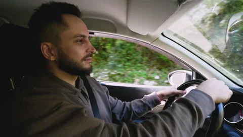 Tourist man inside of car drives, trip to mountain region. Highland wood forest Stock Footage 163429162