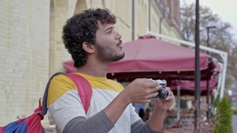 Tourist man mith backpack taking pictures on the camera outside. Stock Footage 163281738