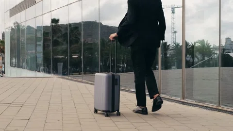 Tourist man with suitcase baggage in spain, A traveler with luggage suit jacket 库存影片 288111413