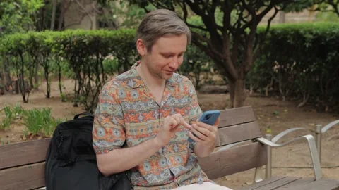 Tourist man using smartphone close up, young man writing message in phone Stock Footage 251821625
