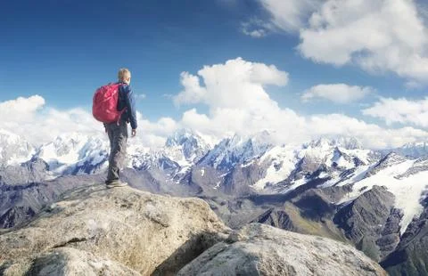 Tourist on the mountain range in the clouds. Active life concept Stock Photos