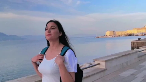 A tourist observes the view while walking along the Gaeta seafront Stock Footage 252222668
