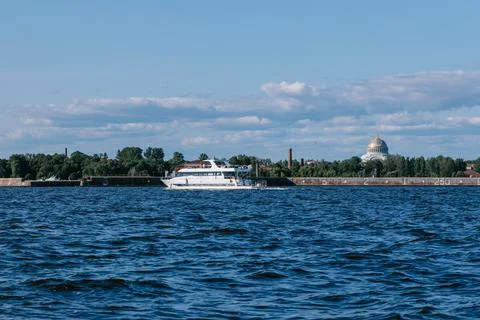A tourist or excursion ship sails in the waters of the Gulf of Finland, the dome Stock Photos