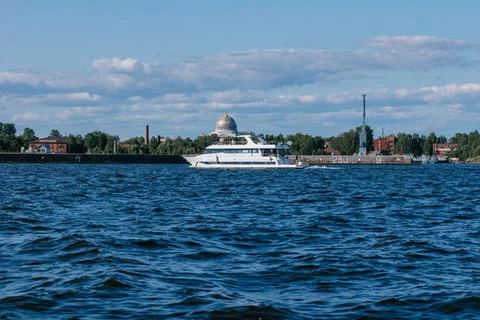 A tourist or excursion ship sails in the waters of the Gulf of Finland, the dome Stock Photos