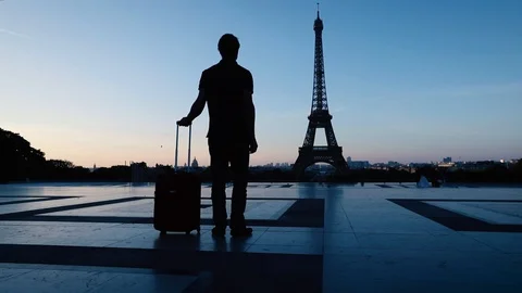 Tourist in Paris looking at Eiffel tower silhouette, tourism in Europe Stock Footage 98099581