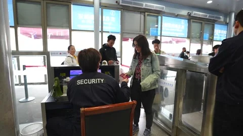 Tourist passport security control in Suzhou train station, China Stock Footage 334649233