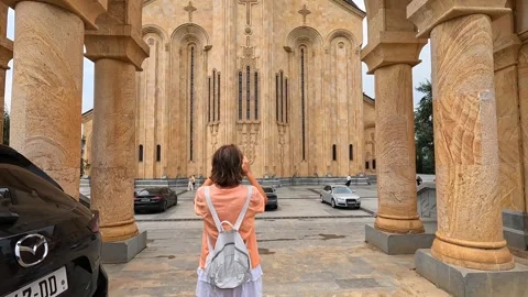 Tourist photographing rear view at Sameba Cathedral in Tbilisi Stock Footage 340386182