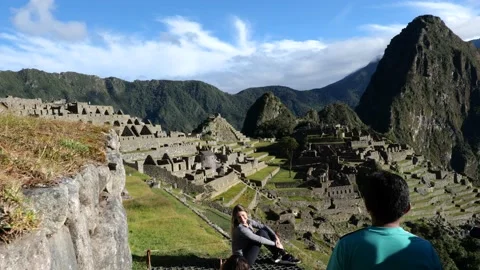 Tourist posing infront of Machu Pichu, Peru 4k Stock Footage 163333174