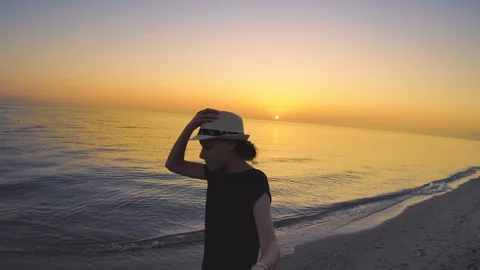 Tourist POV walking on the empty beach at sunrise, enjoying the calm sea Stock Footage 100551962