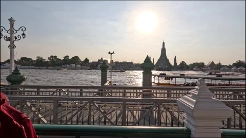 Tourist Reading Map by Riverside Temple at Sunset Stock Footage 324883647