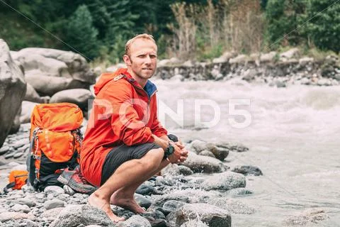 Tourist refresh on the mountain river bank Stock Photos