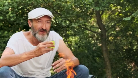The tourist is resting, drinking tea from a mug in the open air. Stock Footage 148338351