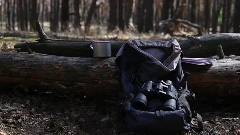 Tourist s backpack, binoculars, a map and equipment for a hike Stock-Footage 150260006
