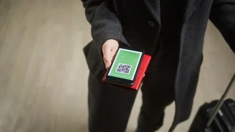 Tourist showing QR code on phone in airport terminal. Vaccination passport Stock Footage 166102636