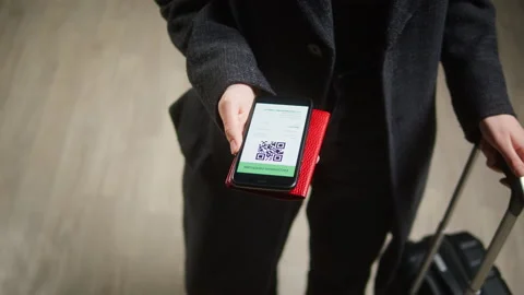 Tourist showing QR code on phone in airport terminal. Vaccination passport Stock Footage 166103733