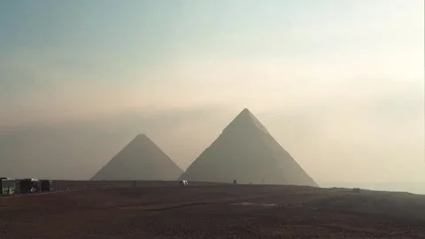 Tourist shuttle buses driving inside the Giza Pyramid Complex with pyramids in Stock Footage 341838223