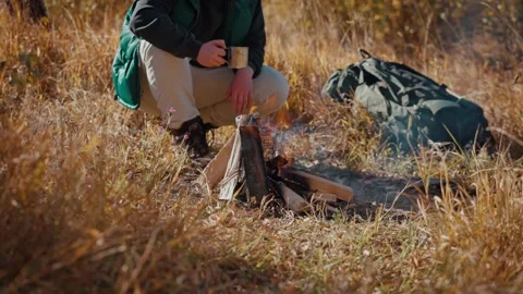 Tourist sitting around campfire Stock Footage 194370539
