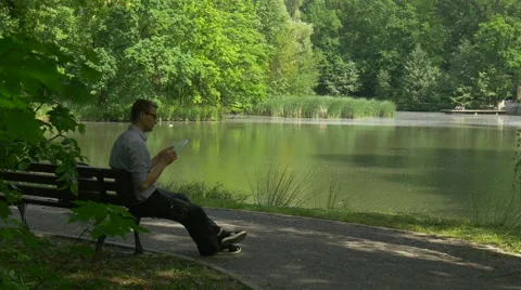 Tourist Sitting on Bench With Virtual Tablet Business Forex Trading Payment Stock Footage 63810385