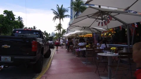 Tourist sitting at pavement cafe while other walking beside it Stock-Footage 116414885