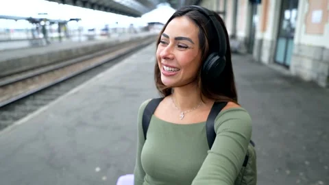 Tourist smiling and walking in train station Stock Footage 311809480