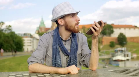 Tourist speaking on loudspeaker while sitting by the castle Stock-Footage 67538993