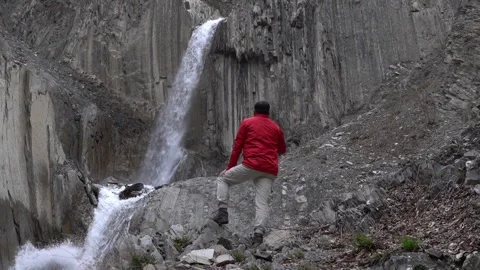 Tourist Standing in Front of Waterfall Video stock 303661121