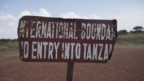 Tourist stop border sign between Kenya and Tanzania African country line Video stock 339968477