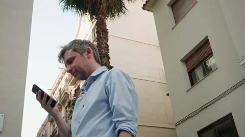 Tourist student using smartphone close-up, young man writing message in phone Stock Footage 202290919