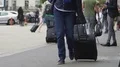 Tourist with suitcase leaving airport, people traveling, slow-motion video HD Footage