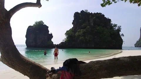 Tourist taking a dip at Koh Hon Island, Krabi, Thailand Stock Footage 130701537