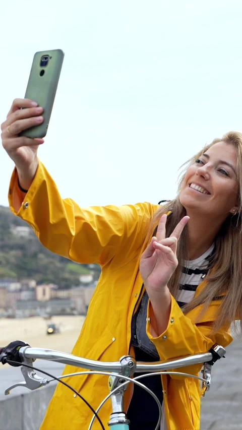Tourist taking selfies with smartphone while riding bicycle Stock Footage 304008746