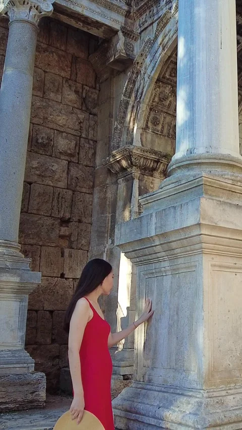 Tourist touching ancient marble column at Hadrian’s Gate in Kaleiçi, Antalya Video stock 317706382