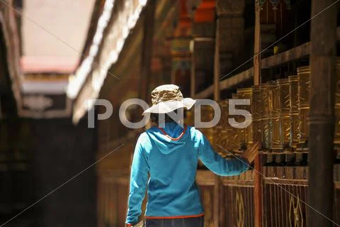 Tourist touching prayer wheel in Jokhang Temple Stock Photos