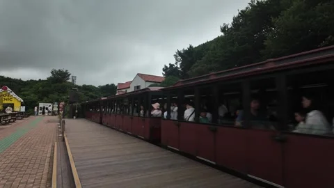 Tourist Train Departing Platform with Passengers on Jeju Island, South Korea Stock Footage 341180452