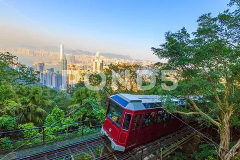Tourist tram at the Peak, Victoria Peak Tram and Hong Kong city skyline. Stock Photos