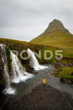 Tourist under the waterfall in Iceland, Adventure photo, edit sp Stock Photos