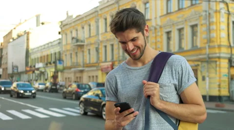 Tourist using his phone in the center of a city Stock Footage 68599077