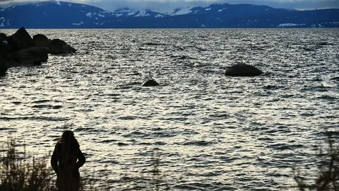Tourist Using Phone on A Stormy Winter Day at Lake Tahoe Nevada Stock Footage 101459064