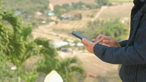 A tourist is using a smartphone for business on a mountain high. Stock Footage 149051925