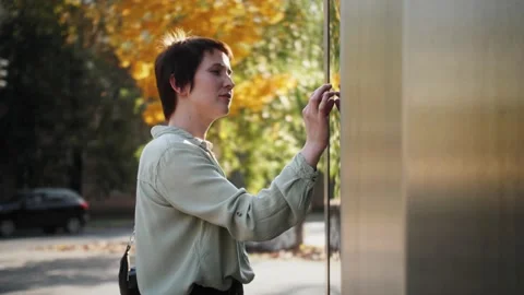 Tourist using touchscreen display of interactive tablet kiosk. Stock Footage 142809883