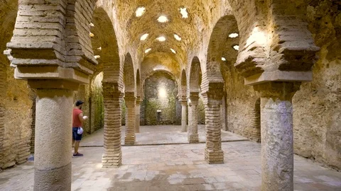 A tourist visit the interior of the arabic baths in Ronda, Spain. Video stock 91969816