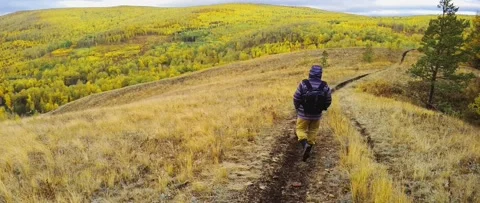 Tourist walking along the path on the top of the mountain Stock Footage 218449823
