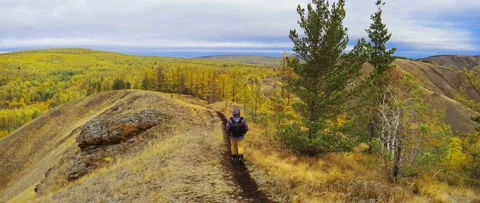 Tourist walking along the path on the top of the mountain Stock Footage 218449974