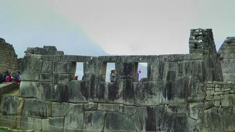 Tourist walking behind windows at Machu Picchu Video stock 305313791
