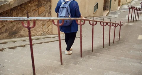 Tourist Walking down Stairs Video stock 129787997