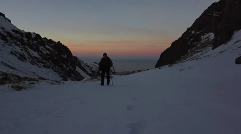 Tourist walking on the snow Stock Footage 60051712