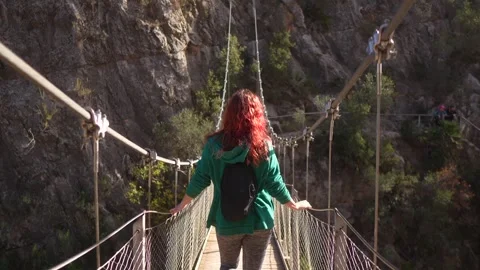 Tourist walking on suspension bridge Stock Footage 262962553