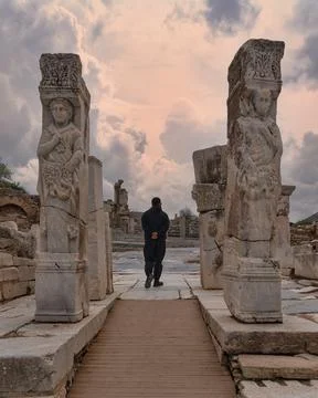 Tourist walking through the ancient Heracles Gate on Curetes Street in Ephesus, Stock Photos